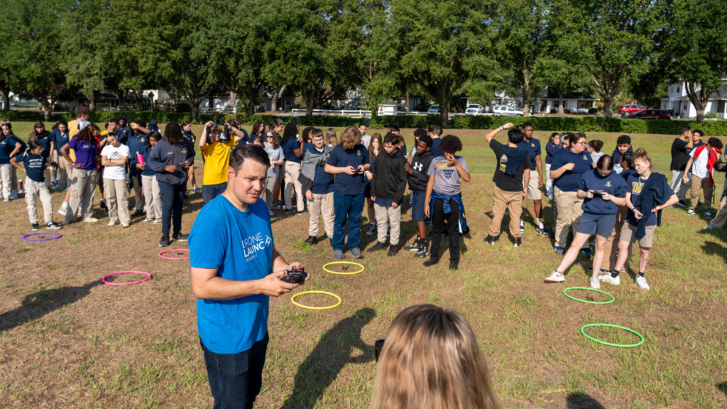 Group of students outdoors with hover circles.