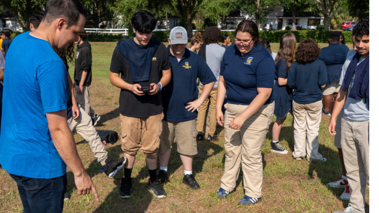 Group of students learning outdoors with an instructor.