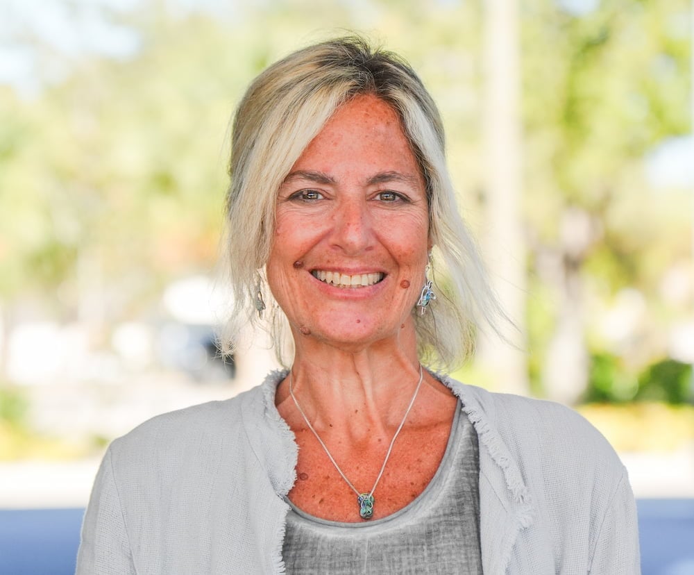 Smiling woman outdoors with blurred background