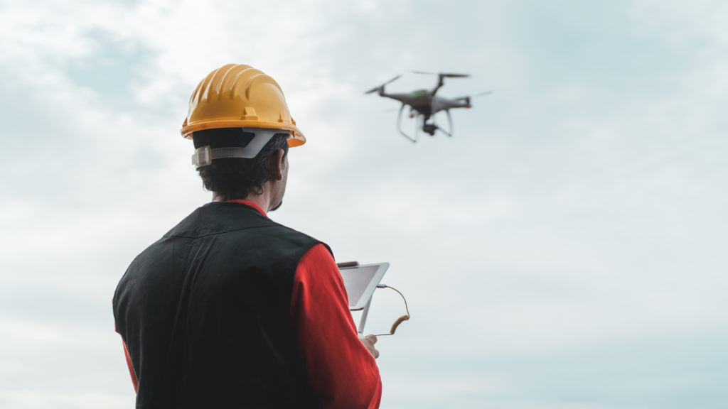 Engineer controlling drone with tablet outdoors