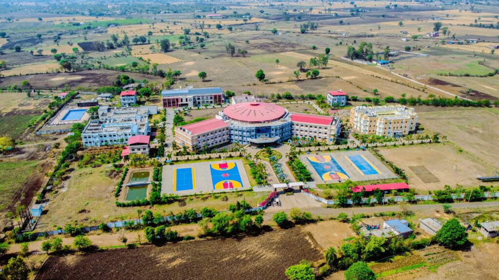 Aerial view of large campus with sports courts.